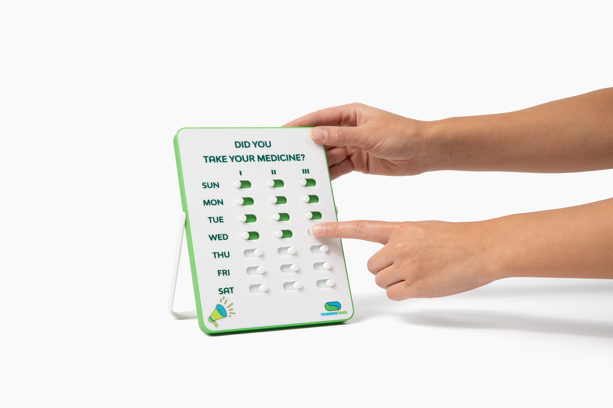 Hand holding a weekly medication reminder chart with days of the week.