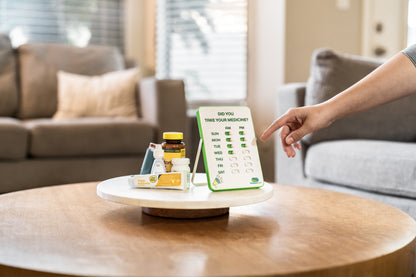 Person interacting with a digital device on a table in a living room setting