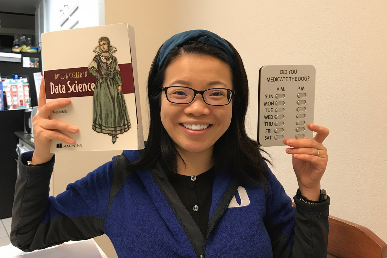 Person holding a book and a small electronic device indoors