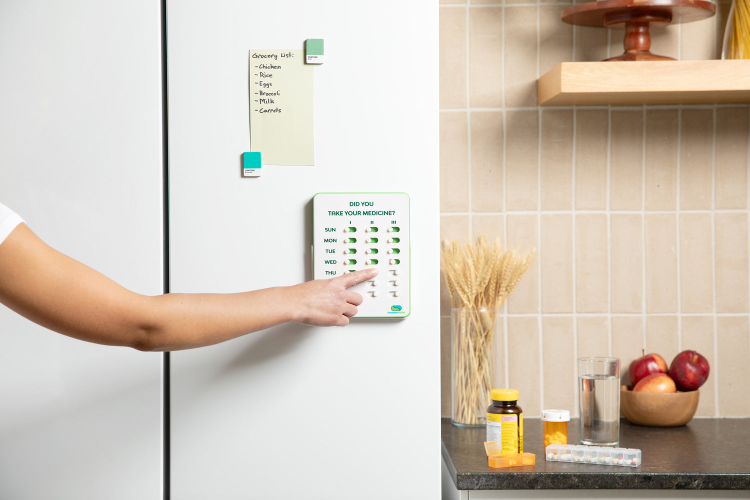 Person interacting with a smart refrigerator in a kitchen setting.